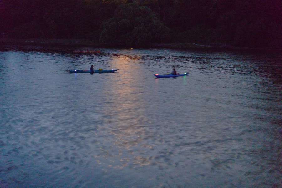 two kayakers in the dark.