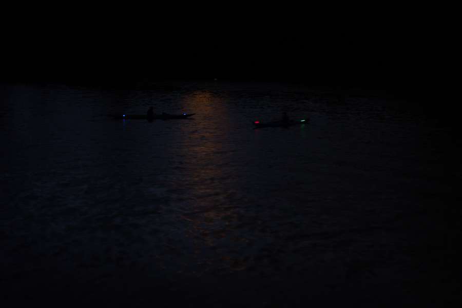 two kayakers in the dark.